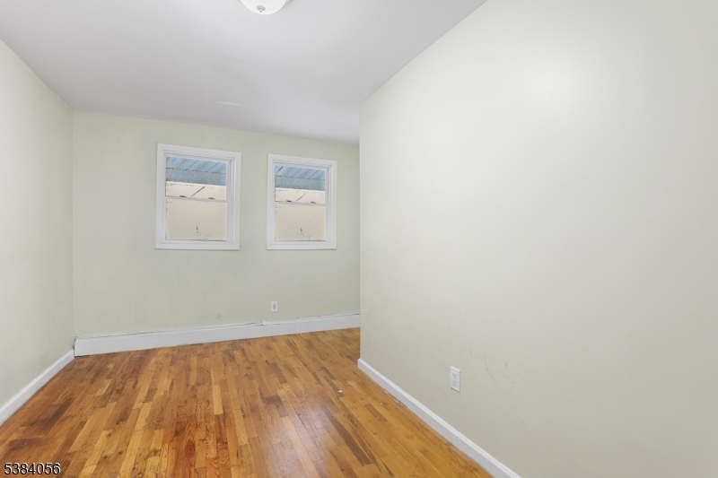 406 South 15th Street Newark, NJ 07103 - Photo 15 of 32 an empty room with wooden floor and windows