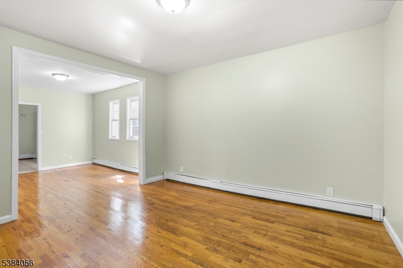 406 South 15th Street Newark, NJ 07103 - Photo 19 of 32 an empty room with wooden floor and windows