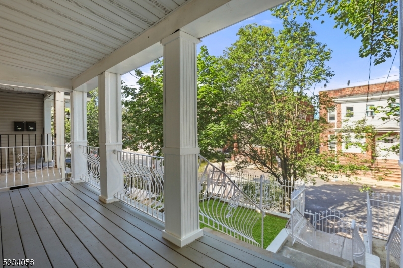 406 South 15th Street Newark, NJ 07103 - Photo 5 of 32 a view of a porch with wooden floor and fence