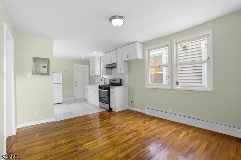 406 South 15th Street Newark, NJ 07103 - Photo 9 of 32 a view of a kitchen with wooden floor and a kitchen space