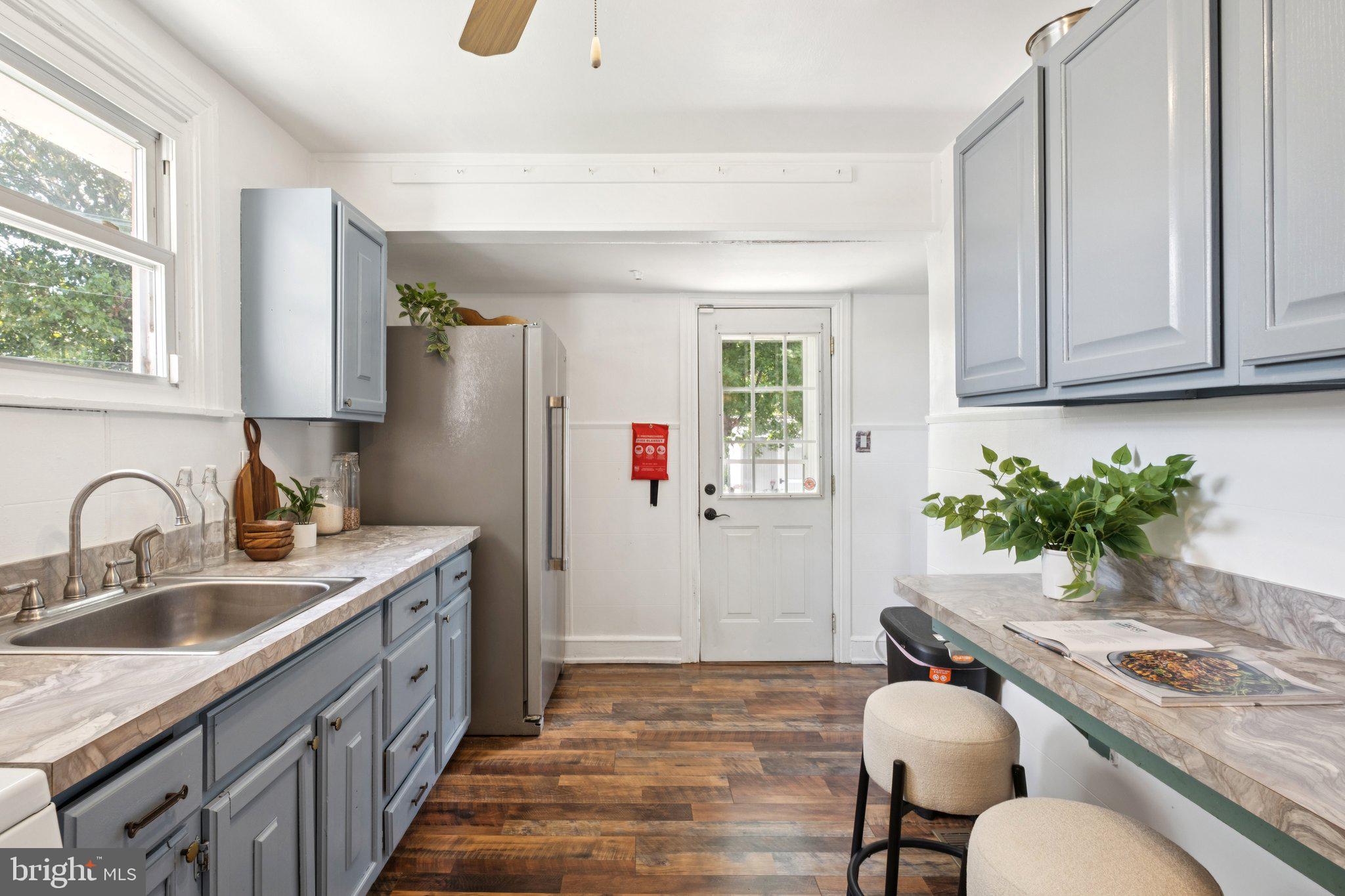 20 West Forestview Road Brookhaven, PA 19015 - Photo 12 of 34 a kitchen with a granite countertop sink a stove and a refrigerator