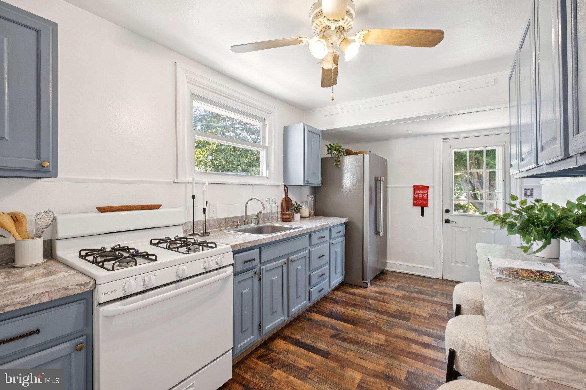 20 West Forestview Road Brookhaven, PA 19015 - Photo 13 of 34 a kitchen with stainless steel appliances kitchen island a stove a refrigerator and a dining table