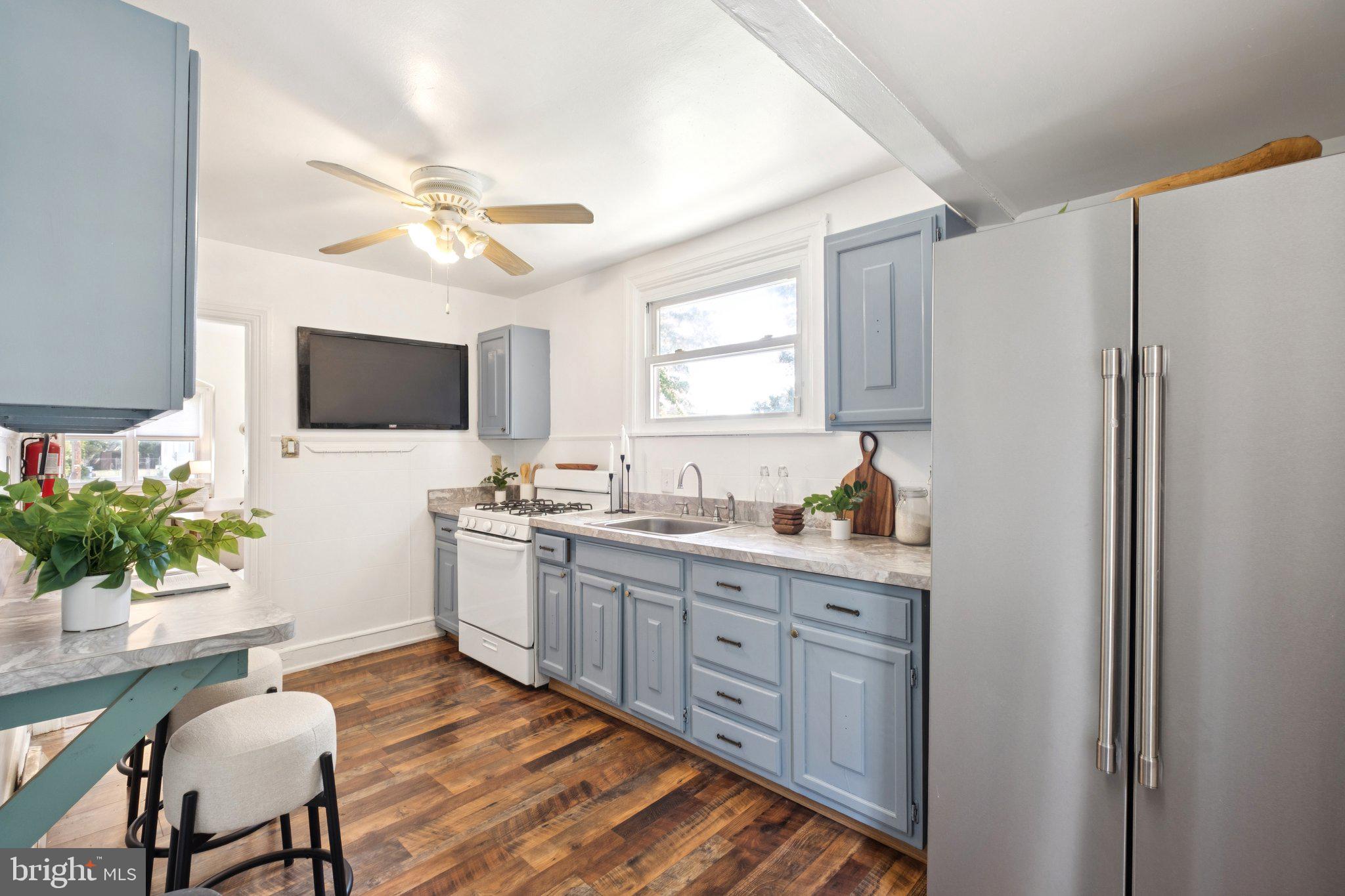 20 West Forestview Road Brookhaven, PA 19015 - Photo 15 of 34 a kitchen with stainless steel appliances a stove a sink refrigerator dining table and chairs