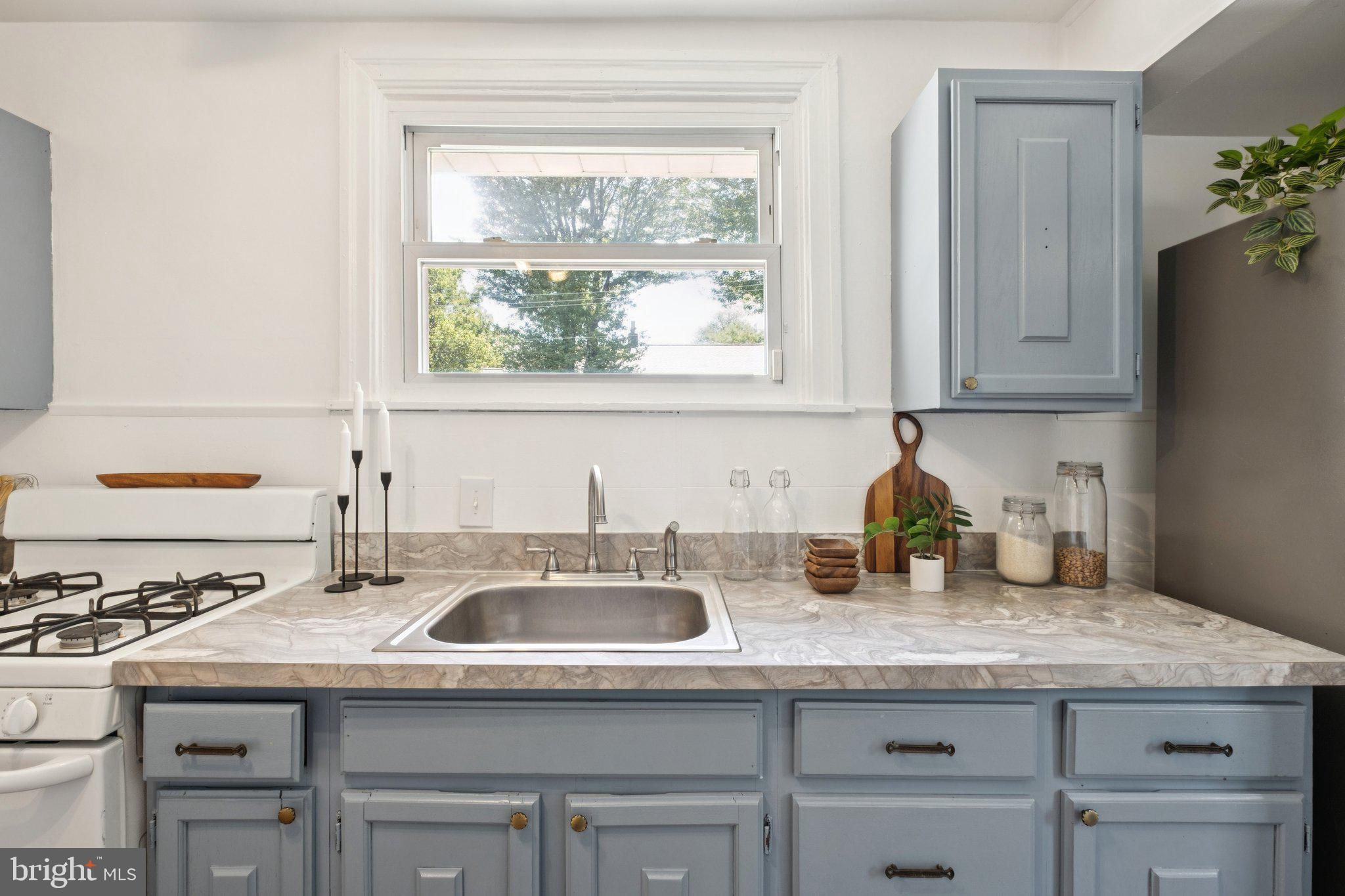 20 West Forestview Road Brookhaven, PA 19015 - Photo 16 of 34 a kitchen with granite countertop kitchen island wooden cabinets and a window