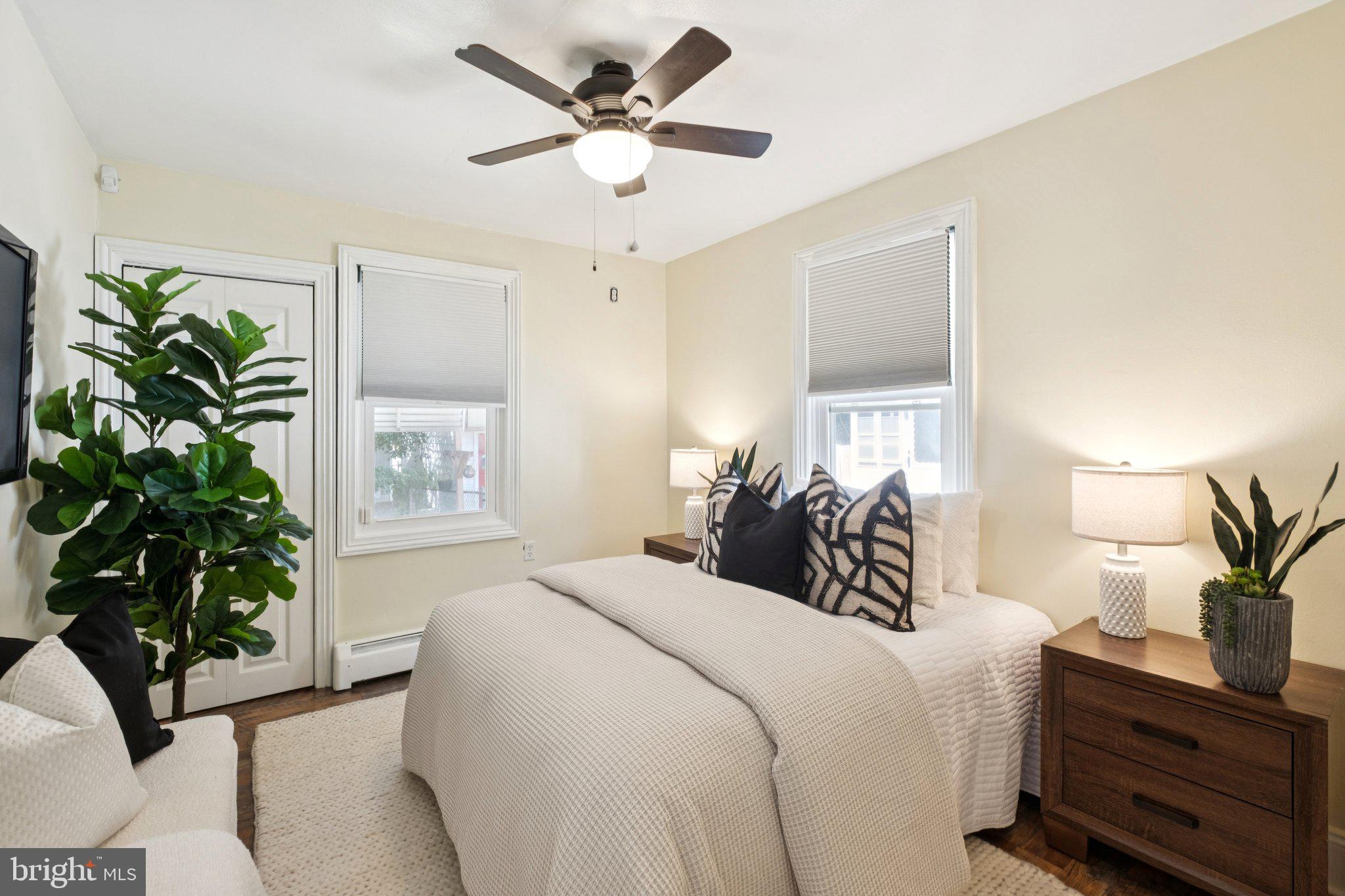 20 West Forestview Road Brookhaven, PA 19015 - Photo 17 of 34 a bedroom with a bed and a potted plant