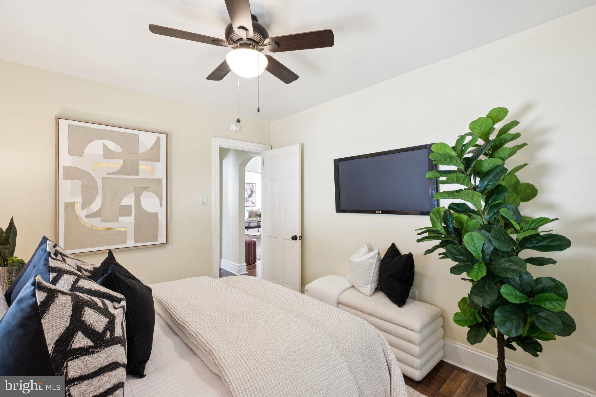 20 West Forestview Road Brookhaven, PA 19015 - Photo 18 of 34 a bedroom with a bed potted plant on the dresser and a chandelier