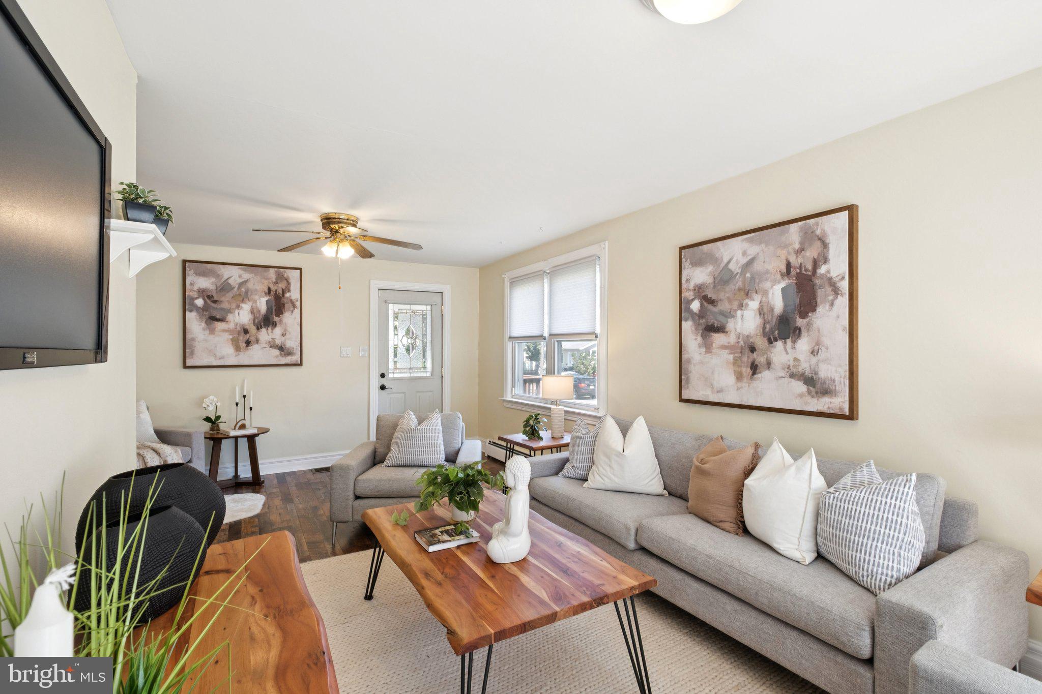 20 West Forestview Road Brookhaven, PA 19015 - Photo 6 of 34 a living room with furniture a couch and paintings on the wall