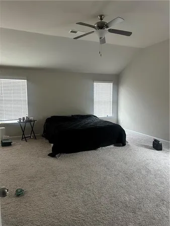 a bedroom with a bed and window