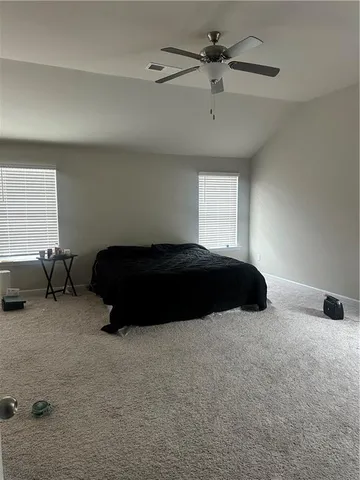 a bedroom with a bed and window