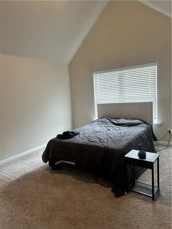 a bedroom with a bed and a window