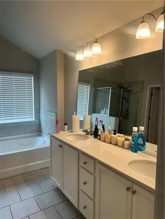 a bathroom with a sink double vanity granite and a mirror