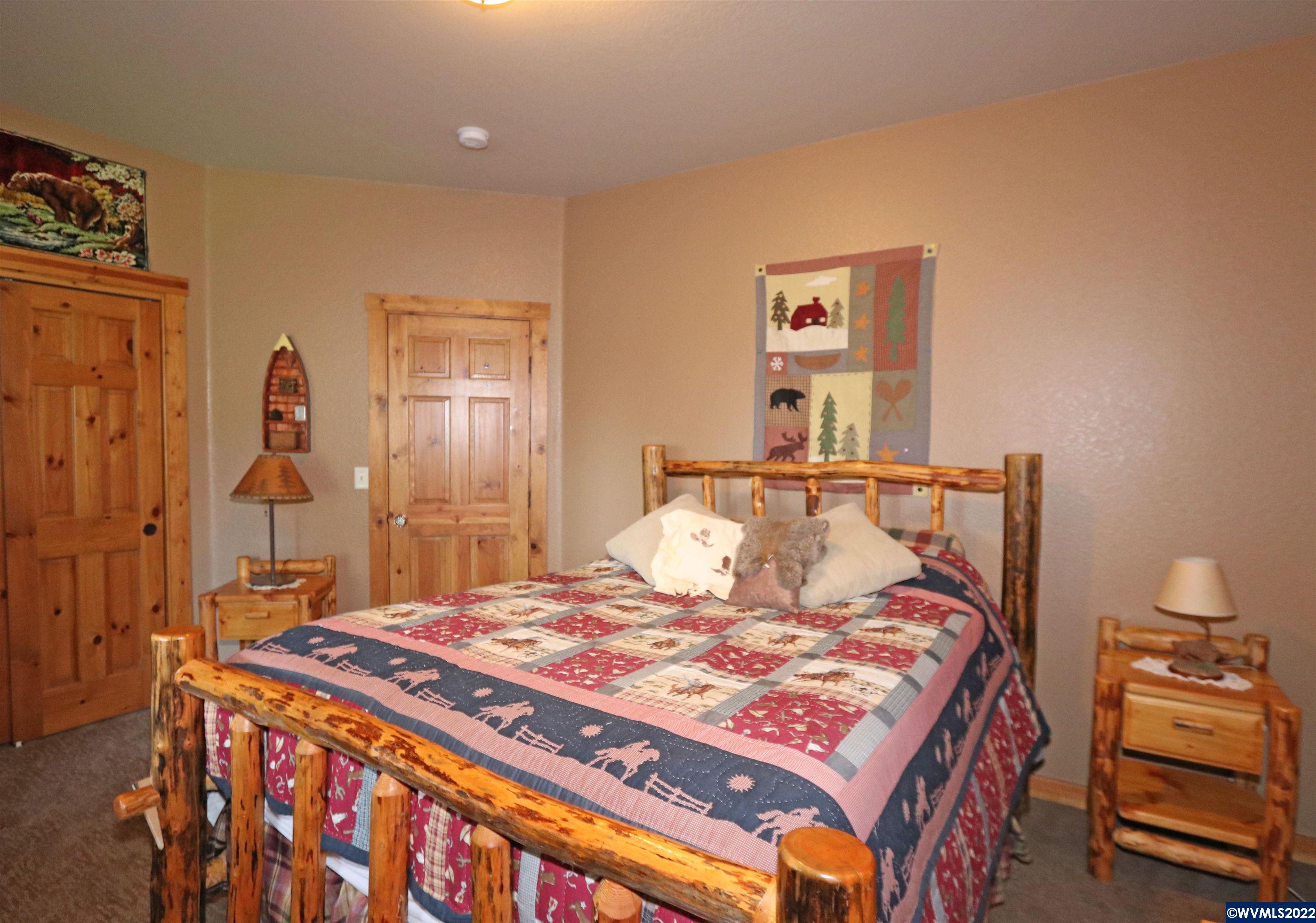 16955 Selden Road Dallas, OR 97338 - Photo 27 of 41 a bedroom with a bed and a lamp with the table