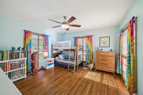a bedroom with furniture and a book shelf