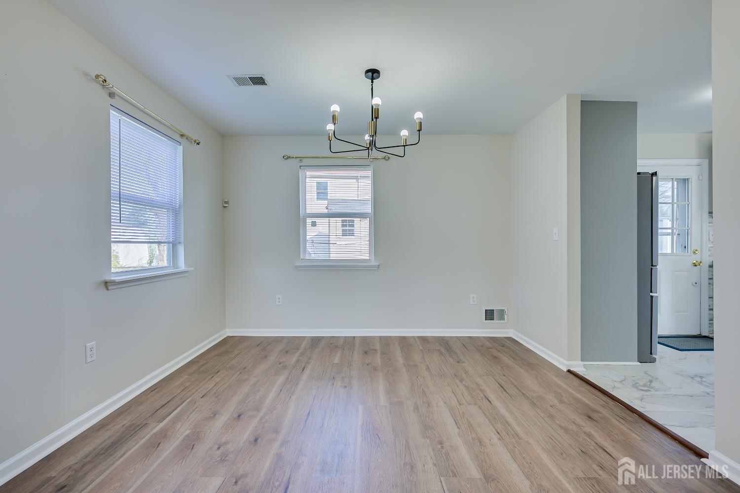 17 Idlewild Road Edison, NJ 08817 - Photo 12 of 36 wooden floor in an empty room with a window