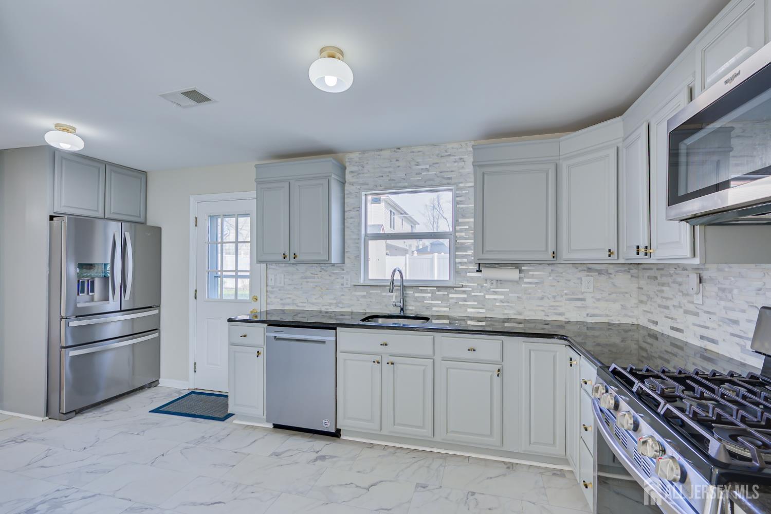 17 Idlewild Road Edison, NJ 08817 - Photo 17 of 36 a kitchen with stainless steel appliances granite countertop a sink and cabinets
