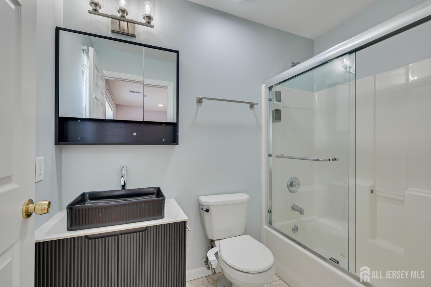 17 Idlewild Road Edison, NJ 08817 - Photo 25 of 36 a bathroom with a toilet sink vanity tub and shower