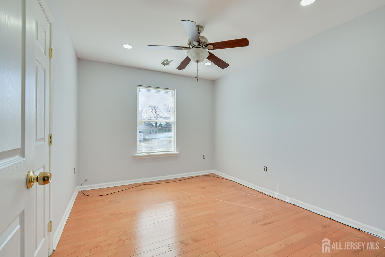 17 Idlewild Road Edison, NJ 08817 - Photo 31 of 36 an empty room with a ceiling fan and window