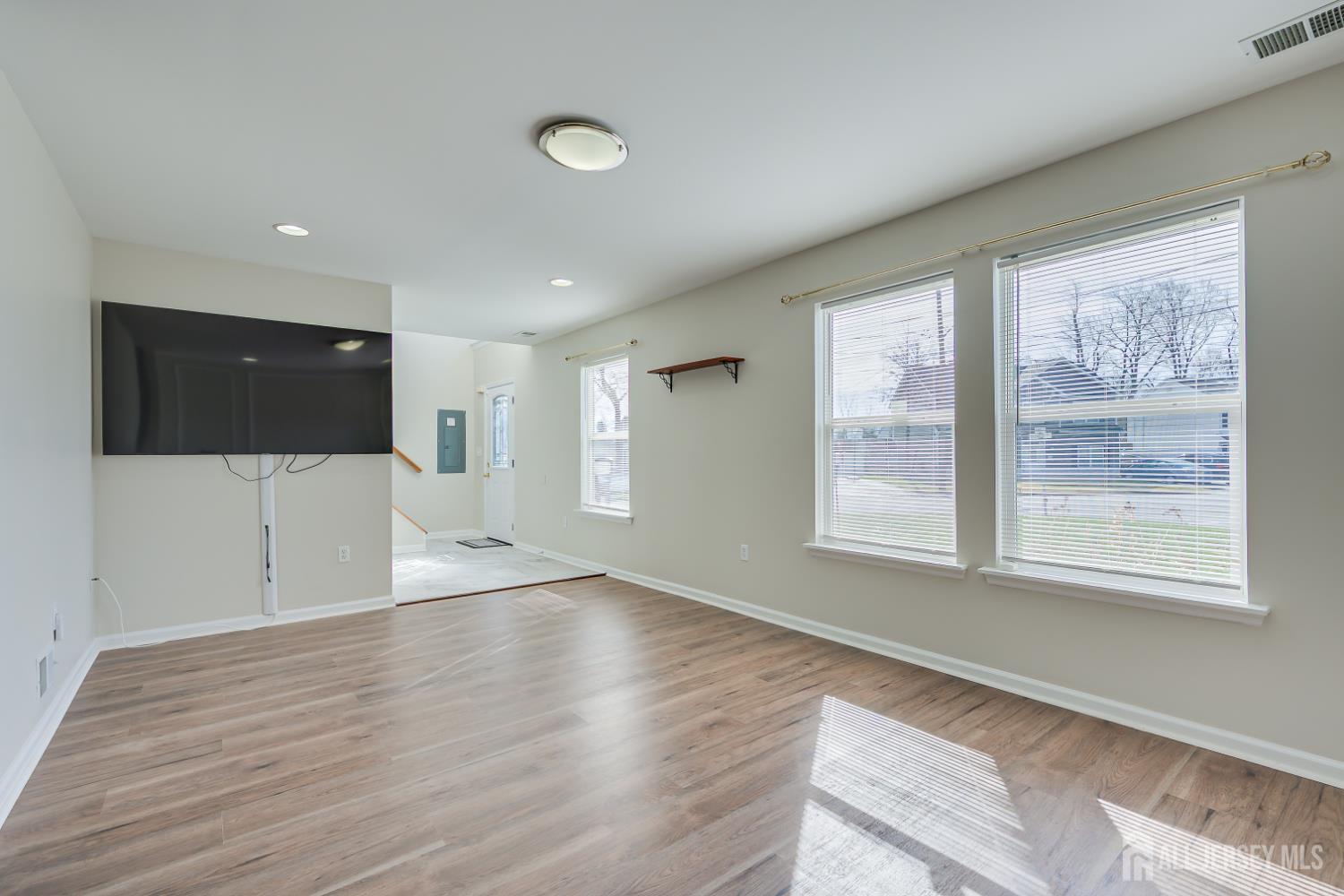 17 Idlewild Road Edison, NJ 08817 - Photo 7 of 36 a view of an empty room with wooden floor and a window