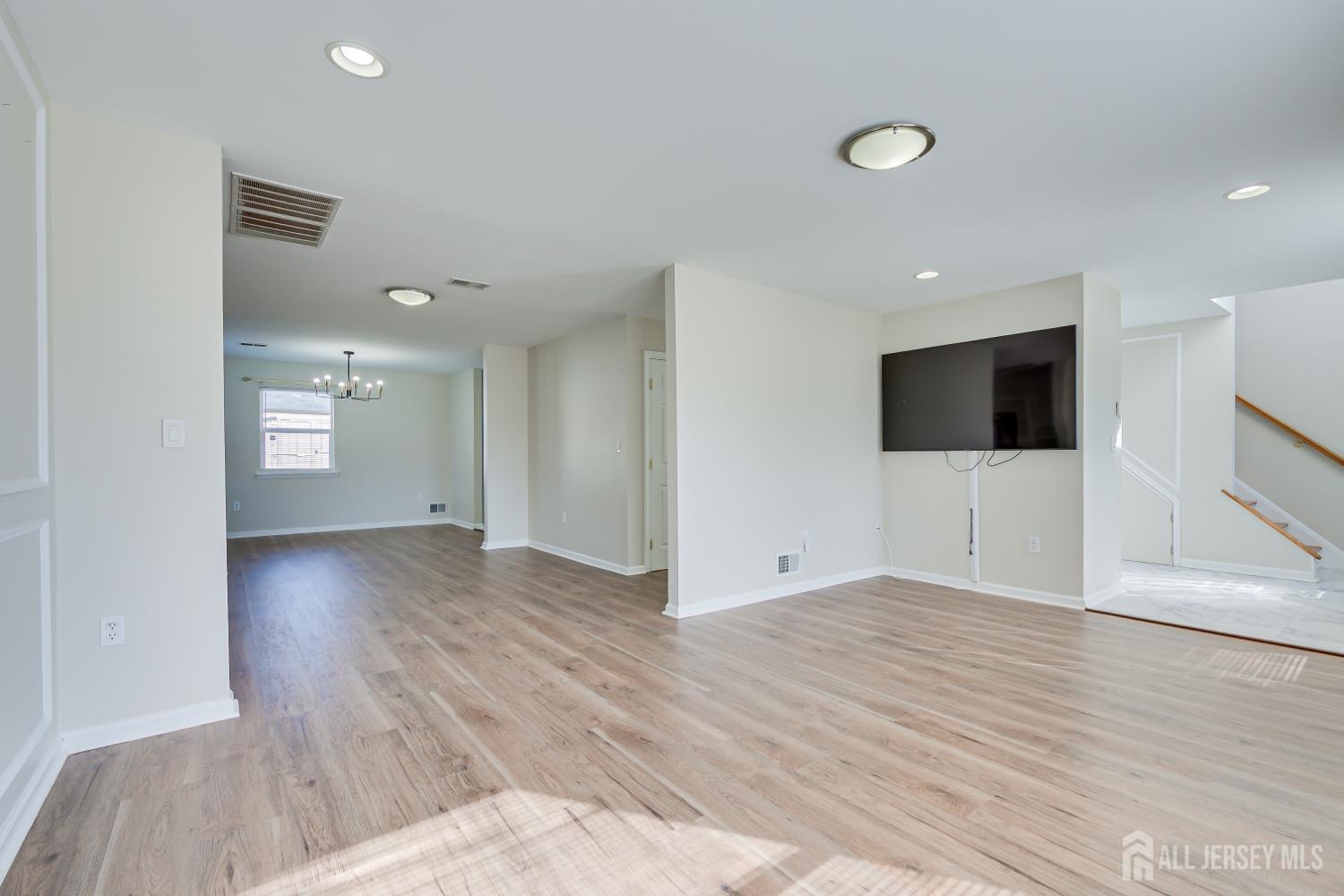 17 Idlewild Road Edison, NJ 08817 - Photo 8 of 36 a view of an empty room with wooden floor and a window