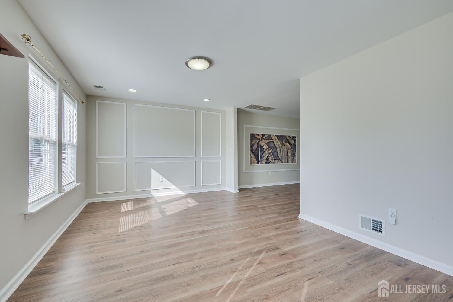 17 Idlewild Road Edison, NJ 08817 - Photo 9 of 36 a view of an empty room with wooden floor and a window