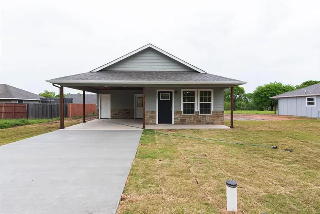 a view of a house with a yard and sitting area