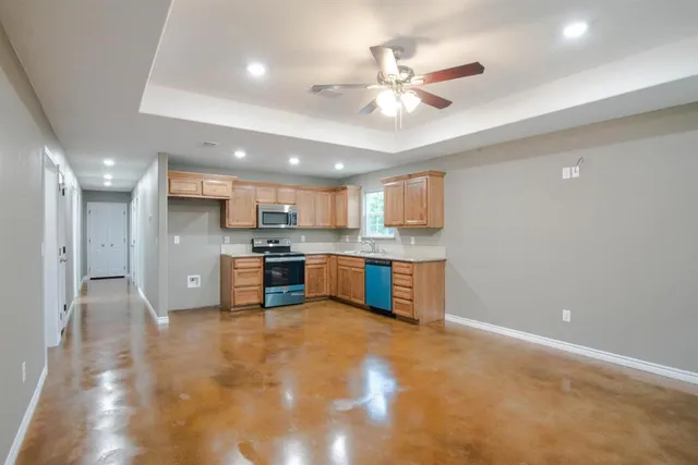 a view of kitchen with kitchen island and stainless steel appliances