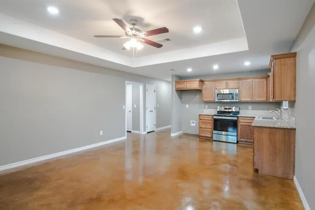 a view of kitchen with stainless steel appliances with cabinets