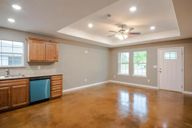 a view of a kitchen with a sink cabinets and wooden floor