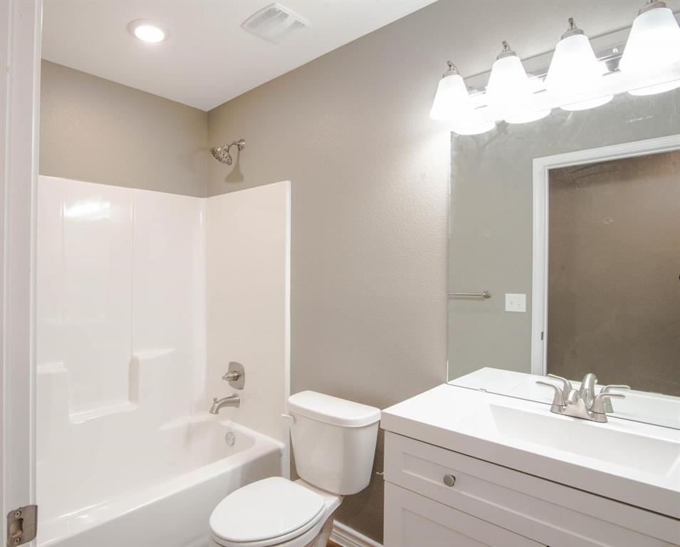 400 Allen Avenue Bonham, TX 75418 - Photo 10 of 14 a bathroom with a sink toilet tub and shower