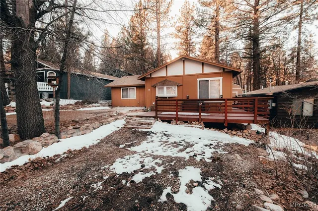 a view of a house with a yard covered in snow