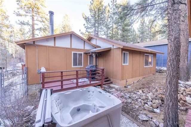 a view of a house with a yard and tree