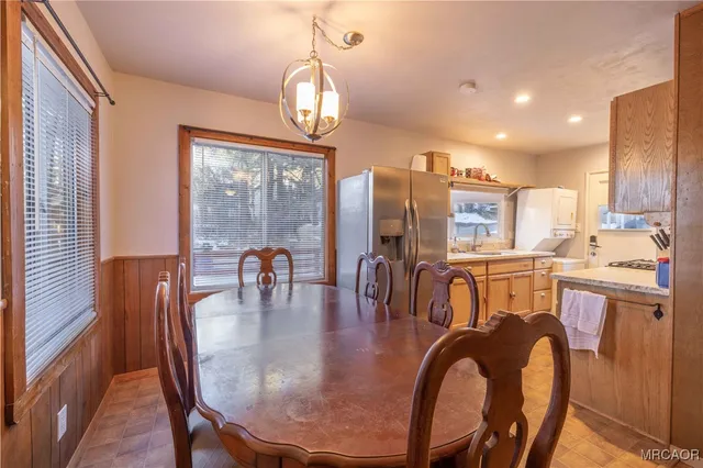 a dining room with furniture and wooden floor