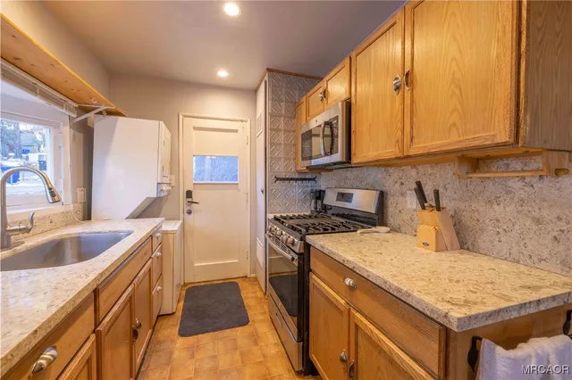 a kitchen with a sink stove and cabinets