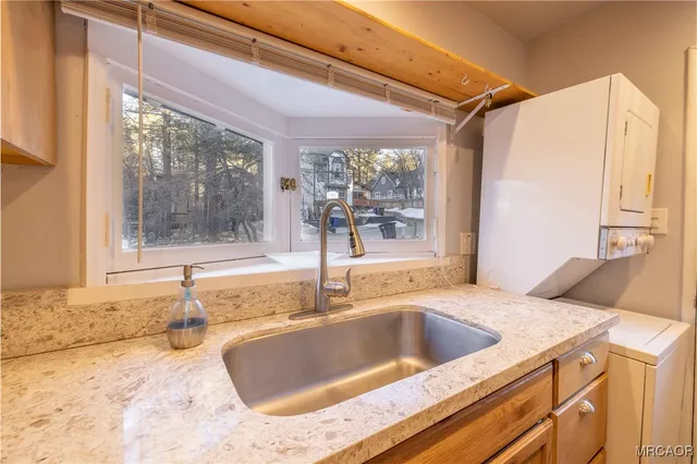 a kitchen with a sink and a large window