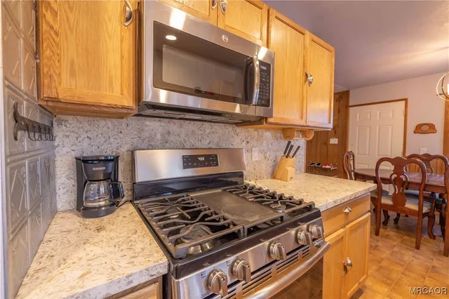 a kitchen with a stove and a microwave