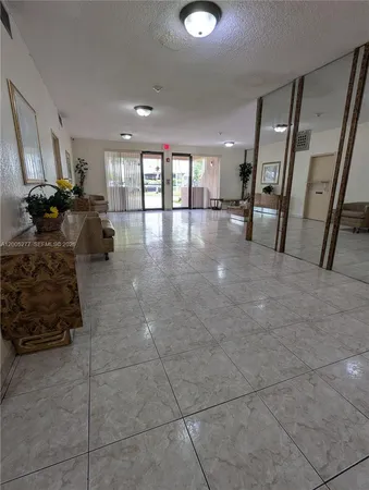 a lobby with furniture and a rug