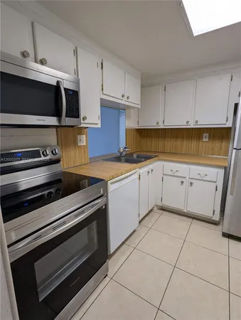 a kitchen with a stove and a microwave