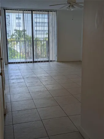a view of a room with wooden floor and windows