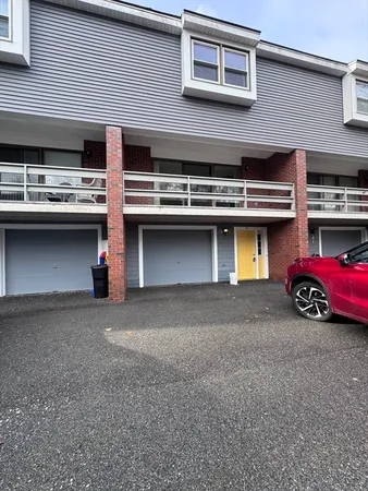 a kitchen with a white stove refrigerator and cabinets