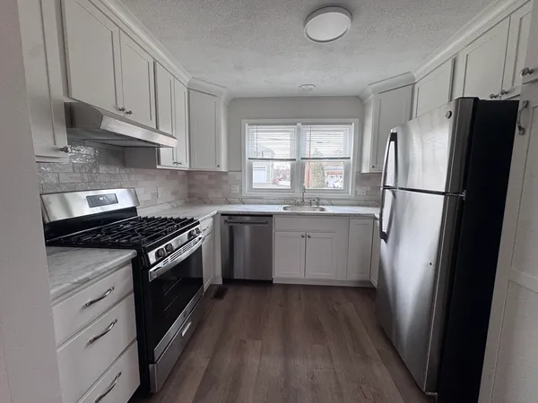 a kitchen with sink and cabinets