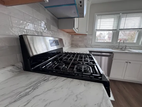 a kitchen with stainless steel appliances granite countertop a refrigerator sink and cabinets