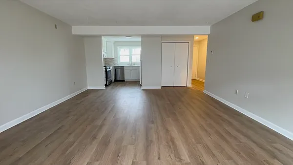 a view of a hallway with wooden floor