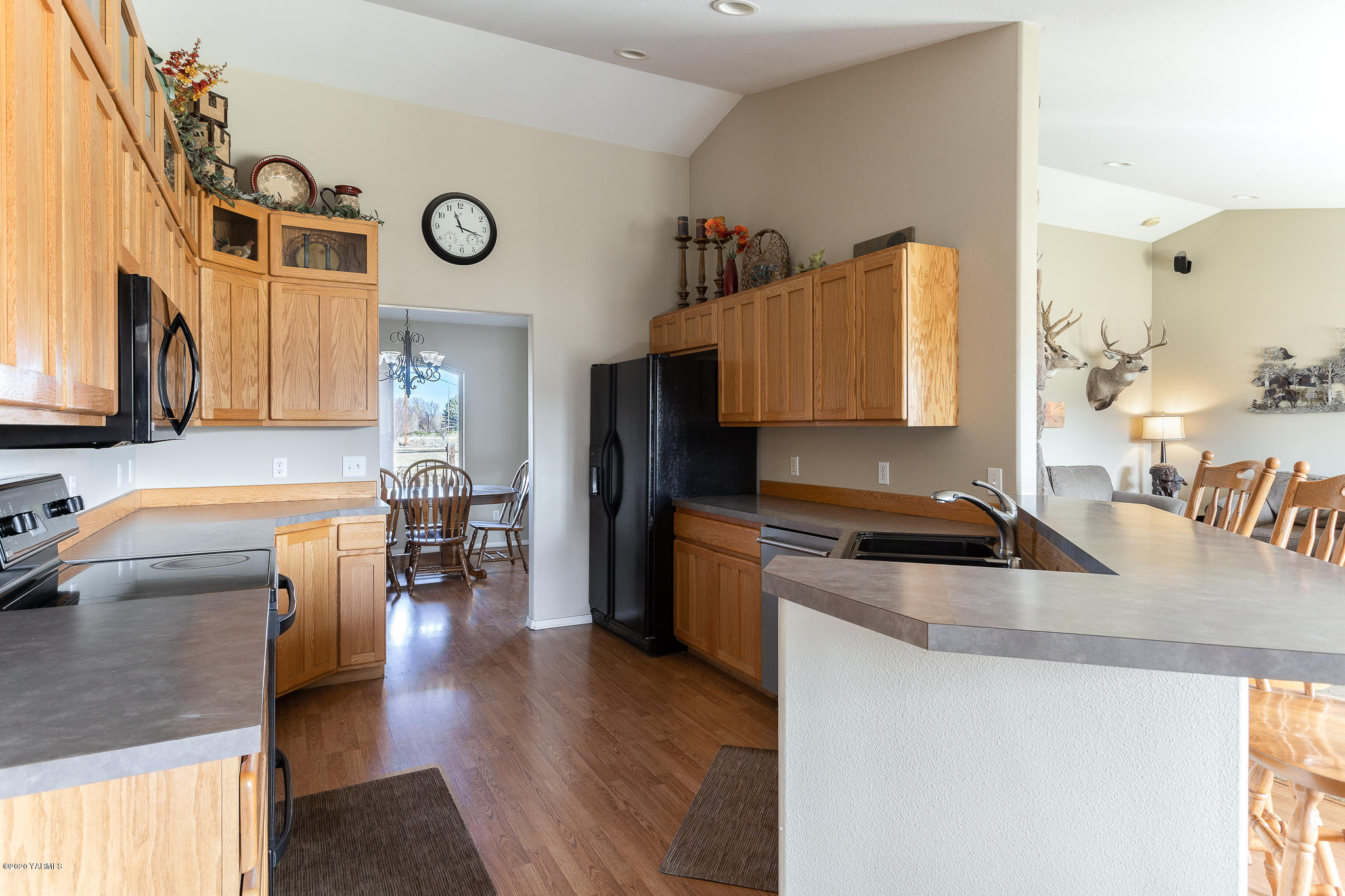 12100 Rutherford Road Yakima, WA 98903 - Photo 19 of 36 a kitchen with a stove cabinets and a refrigerator