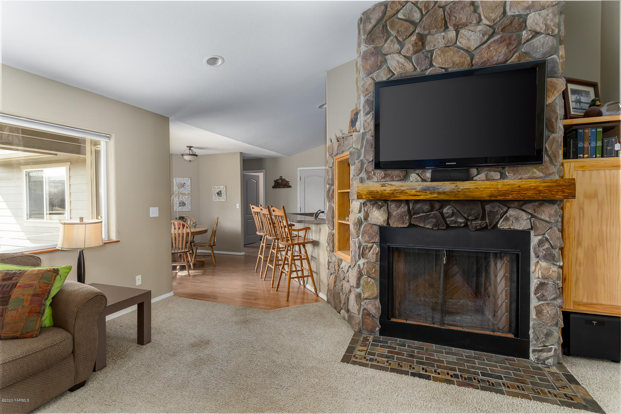 12100 Rutherford Road Yakima, WA 98903 - Photo 21 of 36 a living room with furniture a flat screen tv and a fireplace