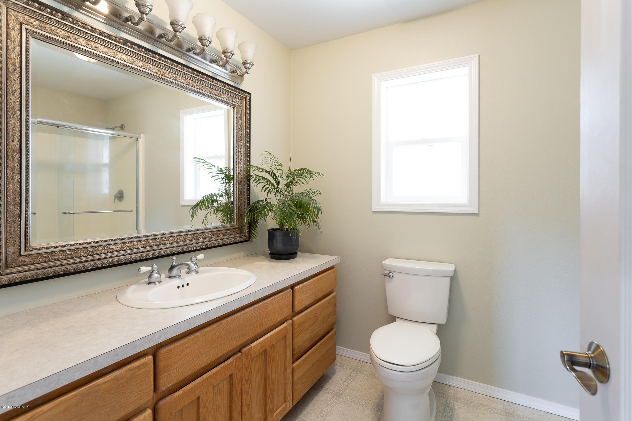 12100 Rutherford Road Yakima, WA 98903 - Photo 25 of 36 a bathroom with a granite countertop toilet a sink and a mirror