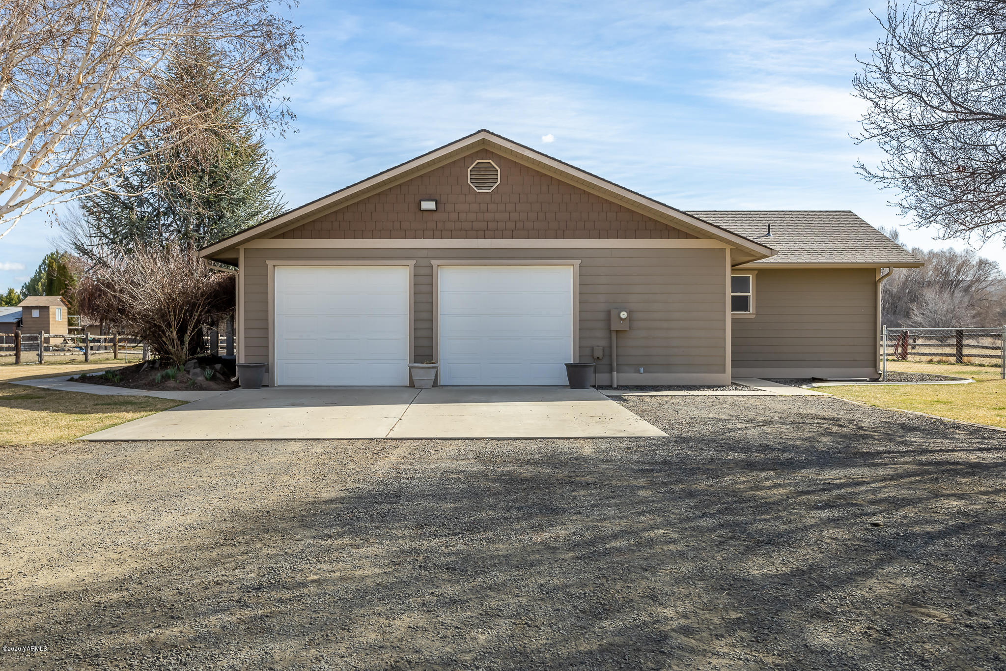 12100 Rutherford Road Yakima, WA 98903 - Photo 4 of 36 a front view of a house with a yard and garage