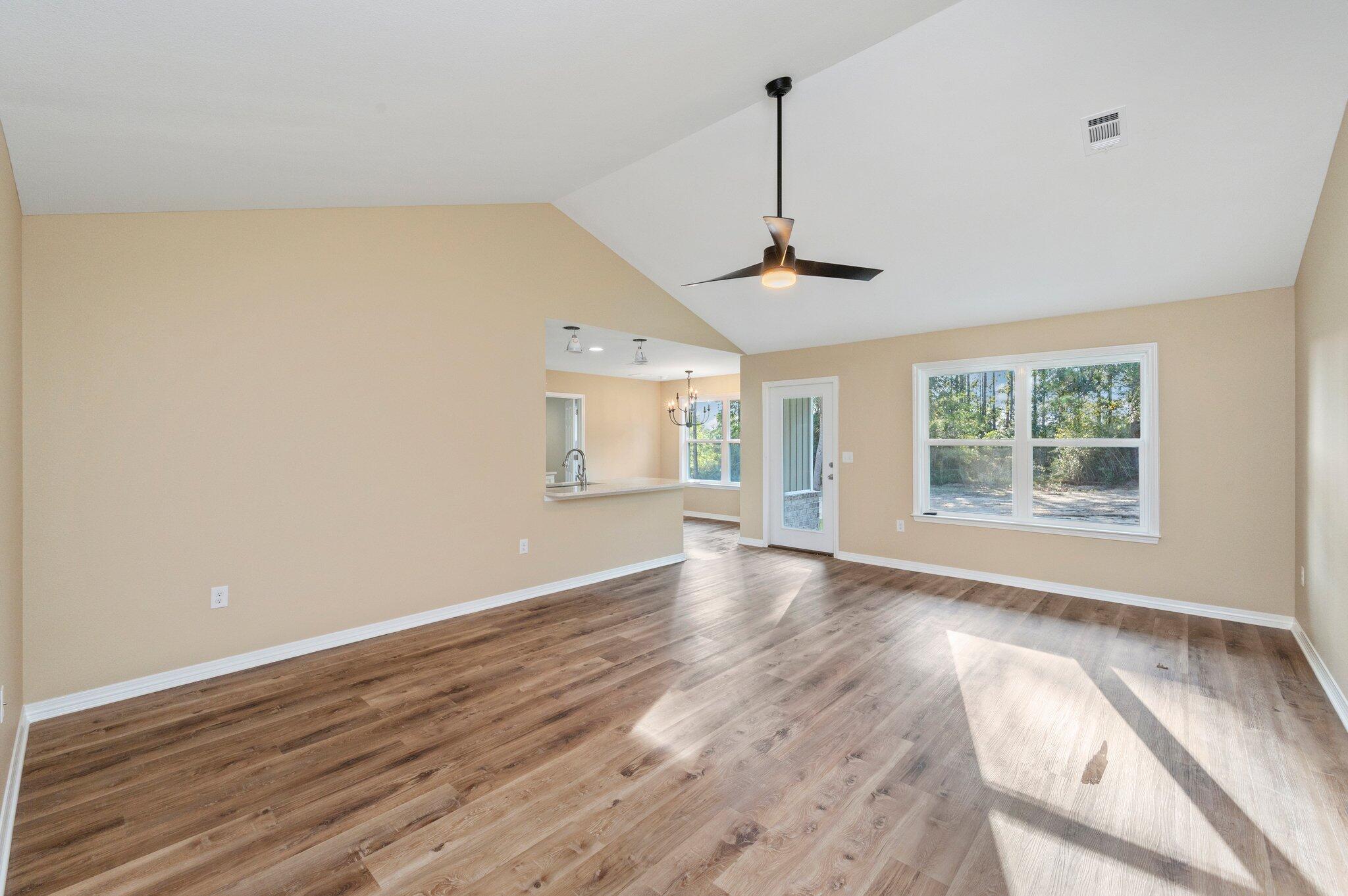 6012 Sand Hill Road Crestview, FL 32539 - Photo 8 of 45 a view of an empty room with wooden floor and a window