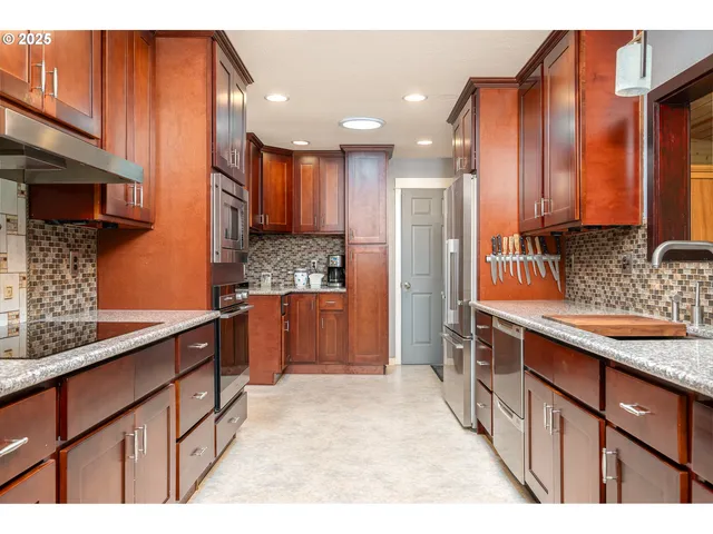 a kitchen with stainless steel appliances granite countertop a sink stove and refrigerator