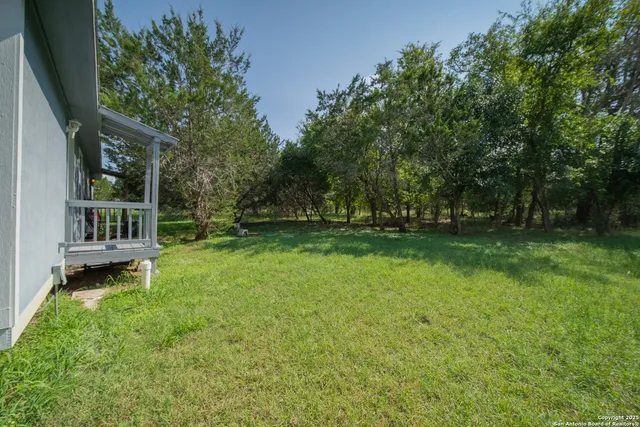 a view of house with backyard