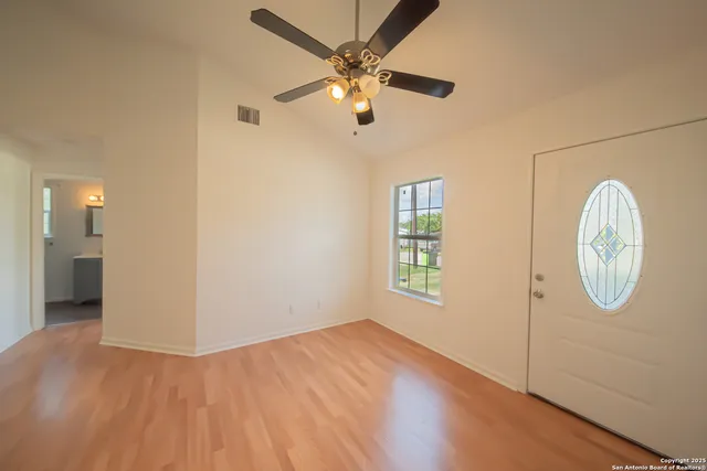 wooden floor in an empty room with a window
